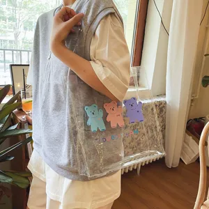 Transparente PVC Schultertasche mit süßen bunten Cartoon Bären Prints, lässiges Detail.
