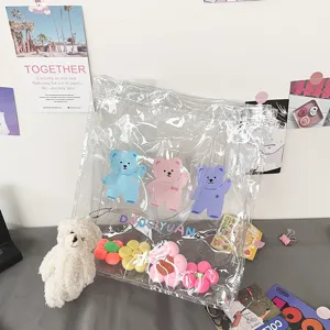 Transparente PVC Tasche Detail mit süßen bunten Bären Drucken, Blumen und Plüsch Anhänger.