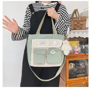 Korean style canvas crossbody bag with multiple pockets, fresh green and white design for students.