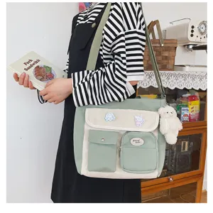 Canvas messenger bag detail showing multi-pockets, cute bear pendant, and fresh aesthetic.