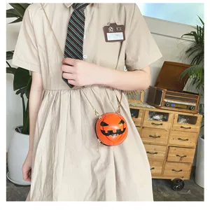 Detail view of the stylish Halloween pumpkin crossbody bag with gold chain strap.