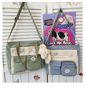 Canvas crossbody bag detail showing multi pockets, cute badges and plush bear pendant.