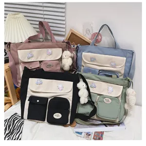 Casual canvas tote bag with multi pockets, cute bear pendant and badges, stylish student shoulder bag.