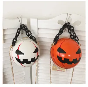 Halloween round crossbody bag with black acrylic chain and devil face design, detailed view.