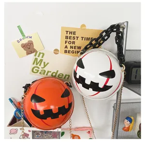 Close-up of Halloween pumpkin round crossbody bags featuring thick acrylic chains and devil faces.