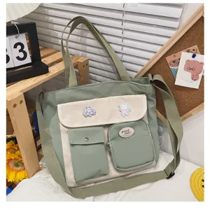 Green canvas crossbody bag with multi pockets, cute badges and casual style for daily use.