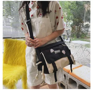Close-up detail of Japanese vintage color-block canvas messenger bag for cute students.