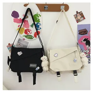 Casual canvas messenger bag with cute bear pendant, large capacity student crossbody bag.