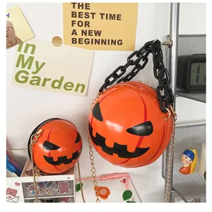 Detail view of cute Halloween pumpkin round shoulder bag with acrylic chain and funny face.