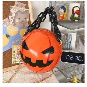 Unique Halloween pumpkin round crossbody bag with chunky black and gold chain, novelty fashion purse.