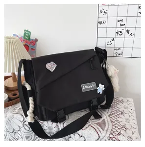 Detailed view of black Japanese Harajuku canvas crossbody bag with flap and metal buckle.