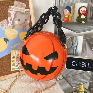 Detailed view of the Halloween pumpkin round shoulder bag featuring bold black chain strap.
