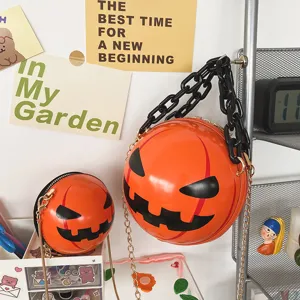 Halloween pumpkin crossbody bag with acrylic chain, cute round novelty shoulder handbag.