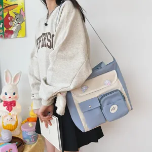 Canvas crossbody bag detail showing multi-pockets, cute pins, and blue white color block.