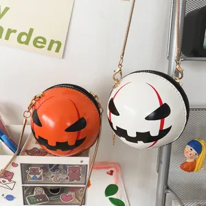 Detail view of creative Halloween pumpkin and devil round crossbody bags with chain straps.