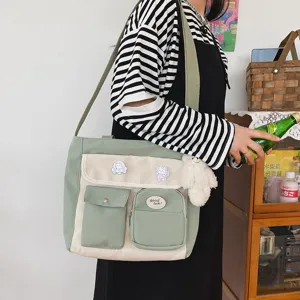 Korean style canvas messenger bag with multi pockets, cute badges and plush pendant student.