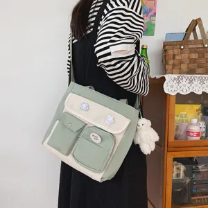 Canvas messenger bag for women, retro casual shoulder bag with multiple pockets and cute pins.