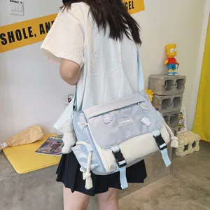 Detailed view of the ulzzang colorblock messenger bag worn, showcasing cute decorative badges.