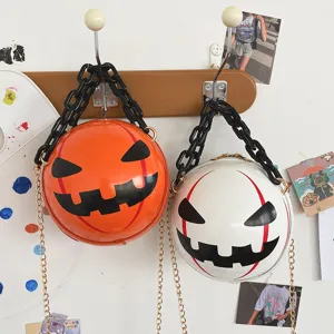 Halloween pumpkin demon round crossbody bag with chunky acrylic and gold chain strap.