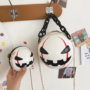 Detail shot of creative halloween devil round crossbody bag with chunky chain and metal strap.
