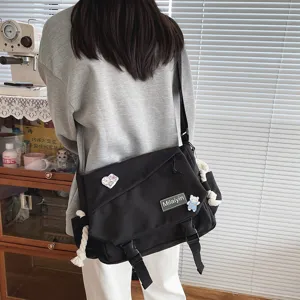 Casual black Harajuku crossbody bag, large capacity student messenger bag with cute badges.
