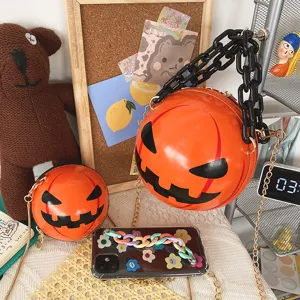 Halloween pumpkin round cross-body bag with black acrylic chain for trendy holiday styling.