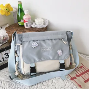 Korean style color block messenger bag with cute badges and casual canvas design.