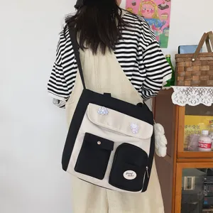 Korean style canvas messenger bag with contrast color, multi-pockets and cute pins for students.