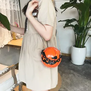 Detail view of creative Halloween pumpkin crossbody bag with acrylic chain and spooky face.
