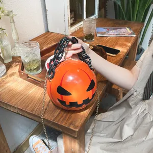 Close-up detail of the creative Halloween pumpkin acrylic chain crossbody bag in bright orange.