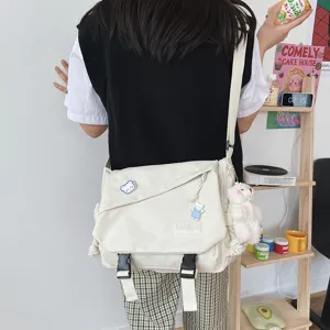 Detail view of Japanese Harajuku minimalist canvas messenger bag with cute bear charm and buckles.