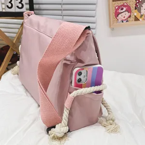 Korean style vintage pink canvas messenger bag with cute tassel and side pocket for daily use.