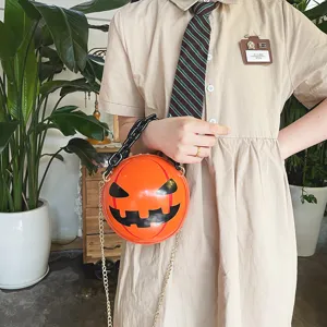 Halloween pumpkin round crossbody bag with chunky acrylic and metal chain straps detail shot.
