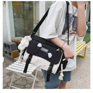 Korean style vintage color block canvas messenger bag detail shot with plush pendant.