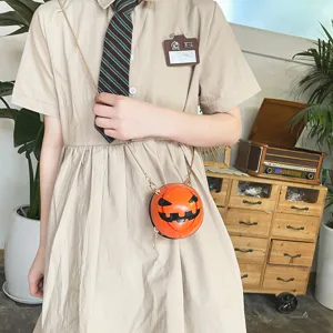 Detailed view of Halloween pumpkin acrylic crossbody bag with spooky face and chain.