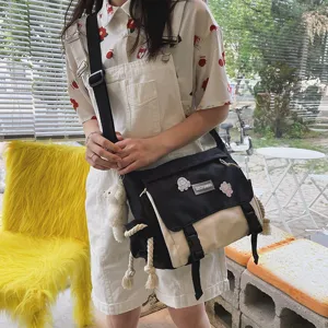 Detailed view of the stylish two-tone canvas crossbody bag worn by model, casual style.
