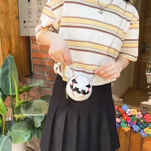Detail view of the funny Halloween pumpkin devil crossbody chain bag, lifestyle scene shot.