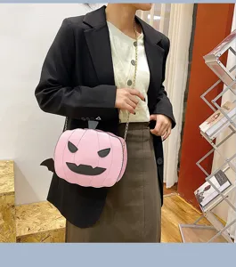 Detailed shot of the pink Halloween pumpkin PU leather crossbody bag worn by model, chic.