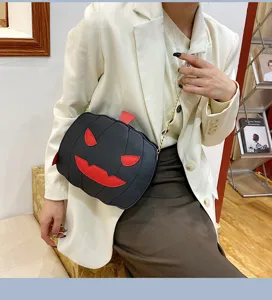 Halloween pumpkin crossbody bag for women, stylish black PU leather shoulder bag with chain strap.