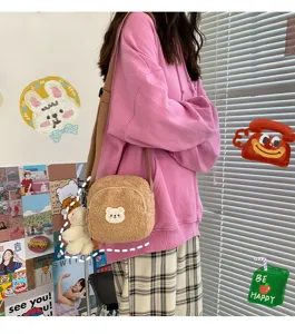 Detail shot of cute fluffy shearling bear crossbody bag with plush pendant for sweet style.