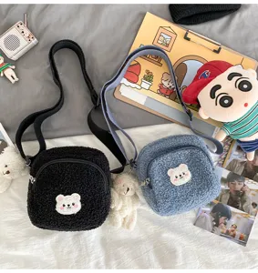 Detail view of fluffy sherpa crossbody bag with cute bear patch, soft winter shoulder bag design.