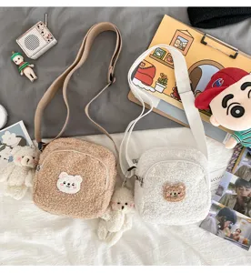 Cute lamb wool crossbody bag for women, cozy sherpa shoulder bag with bear pendant.