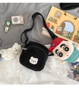 Cute black sherpa crossbody bag with cute bear patch and plush doll charm, vintage style.