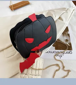 Close-up detail of the black PU leather Halloween pumpkin crossbody bag with red spooky face.