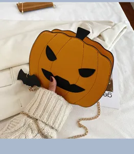 Close-up of Halloween pumpkin PU leather crossbody bag with bat detail and gold chain strap.