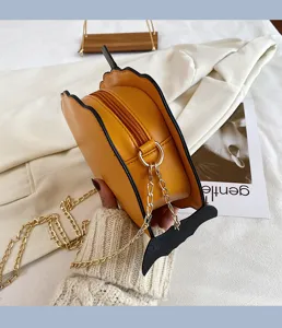 Detailed close-up of yellow PU leather novelty Halloween crossbody bag with metal chain strap.