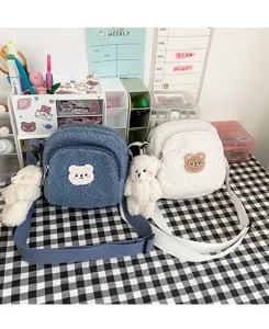 Cute fluffy lamb wool crossbody bag with lovely bear pendant and patch, soft plush detail view.