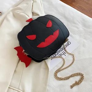 Halloween black pumpkin cross body bag with red devil wings and gold chain strap detail.