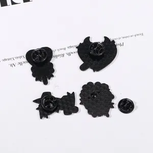 Detailed close-up view of black enamel pin backs and secure clutches, metal brooch display.