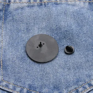 Detailed view of brooch pin back with rubber clutch on denim background accessory